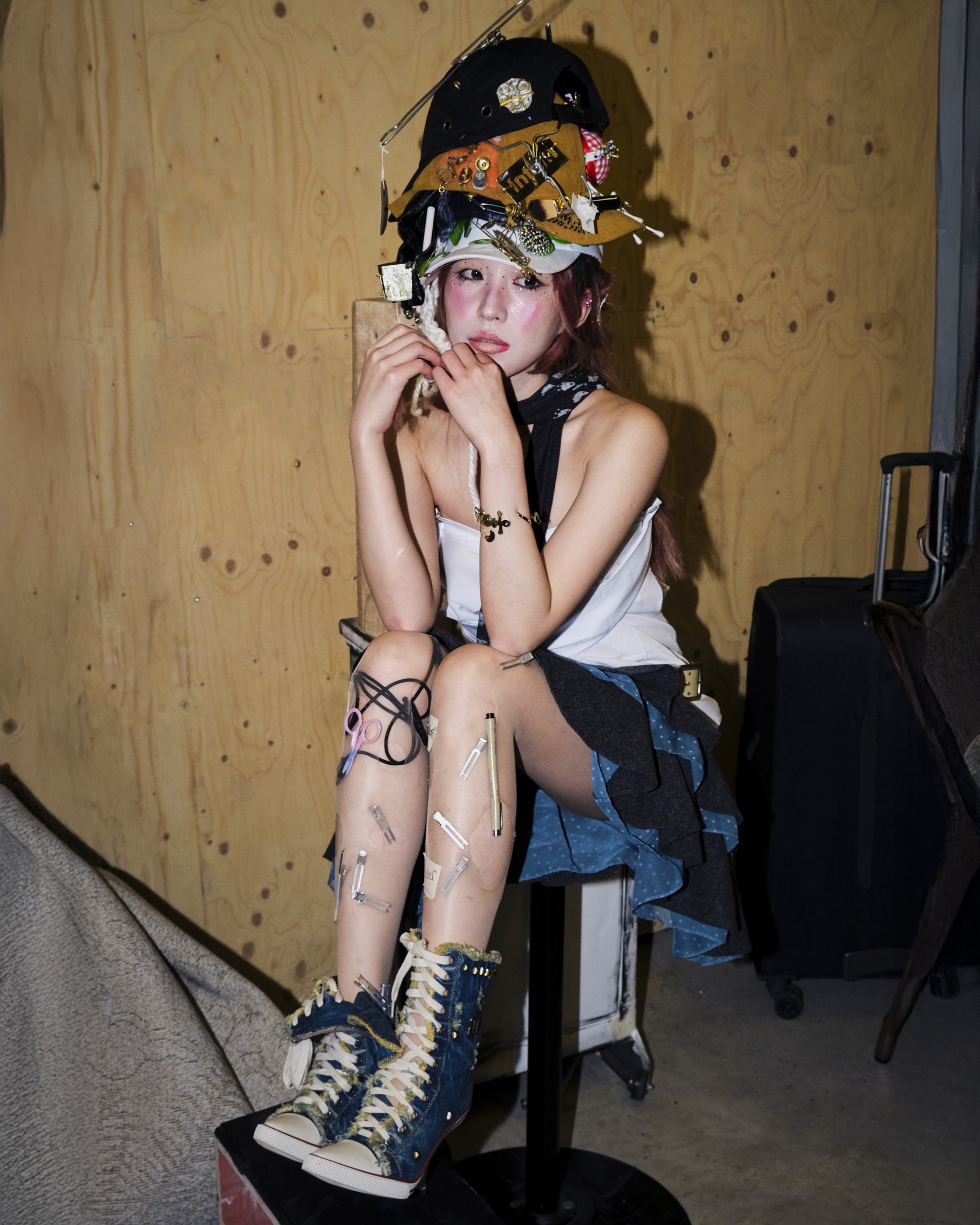 Seated backstage at Central Saint Martins wearing the full set
