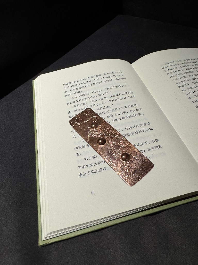 Copper — bookmark on open book