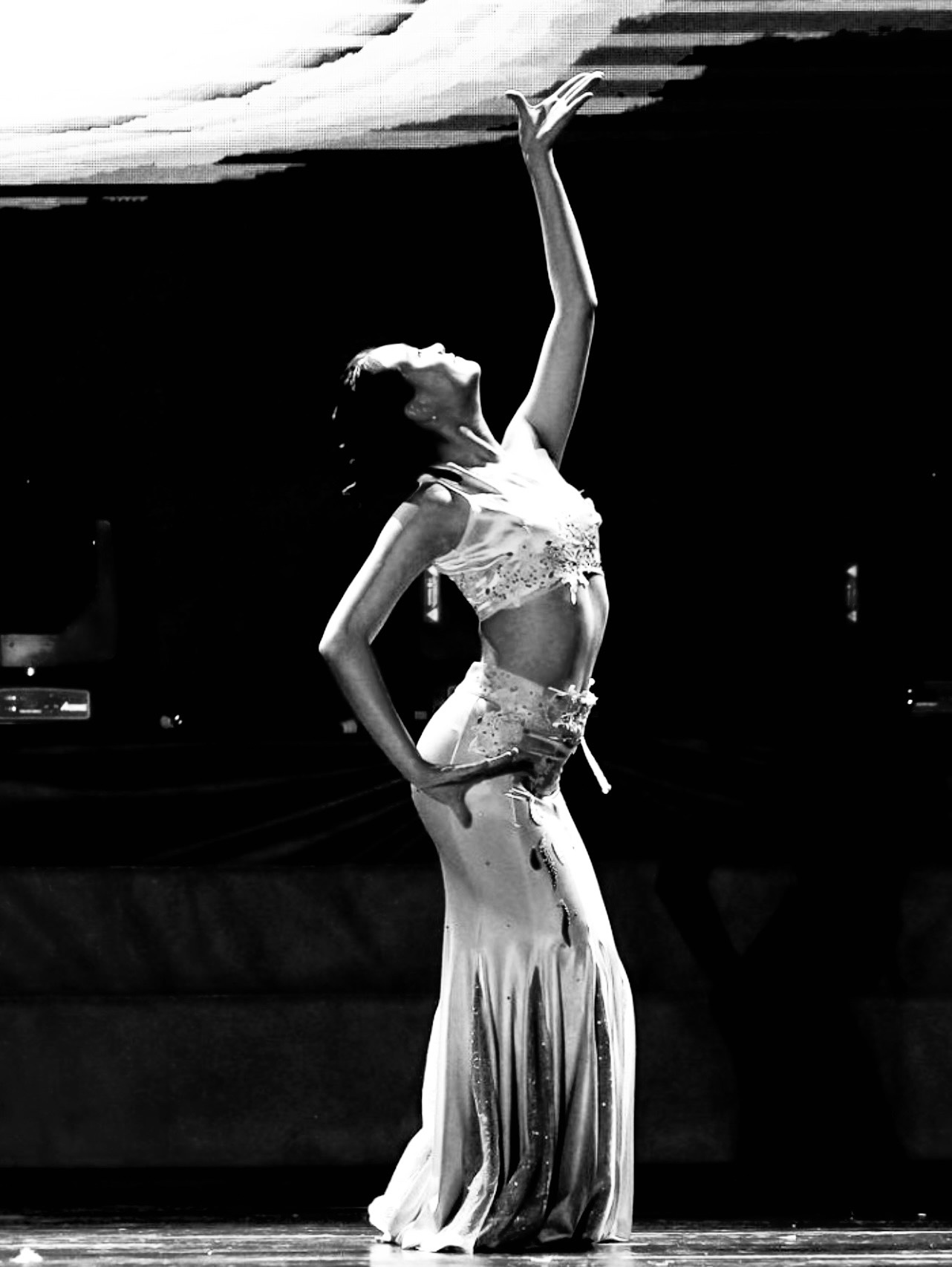 Sia Liu performing Zanha, arm raised in Dai dance pose