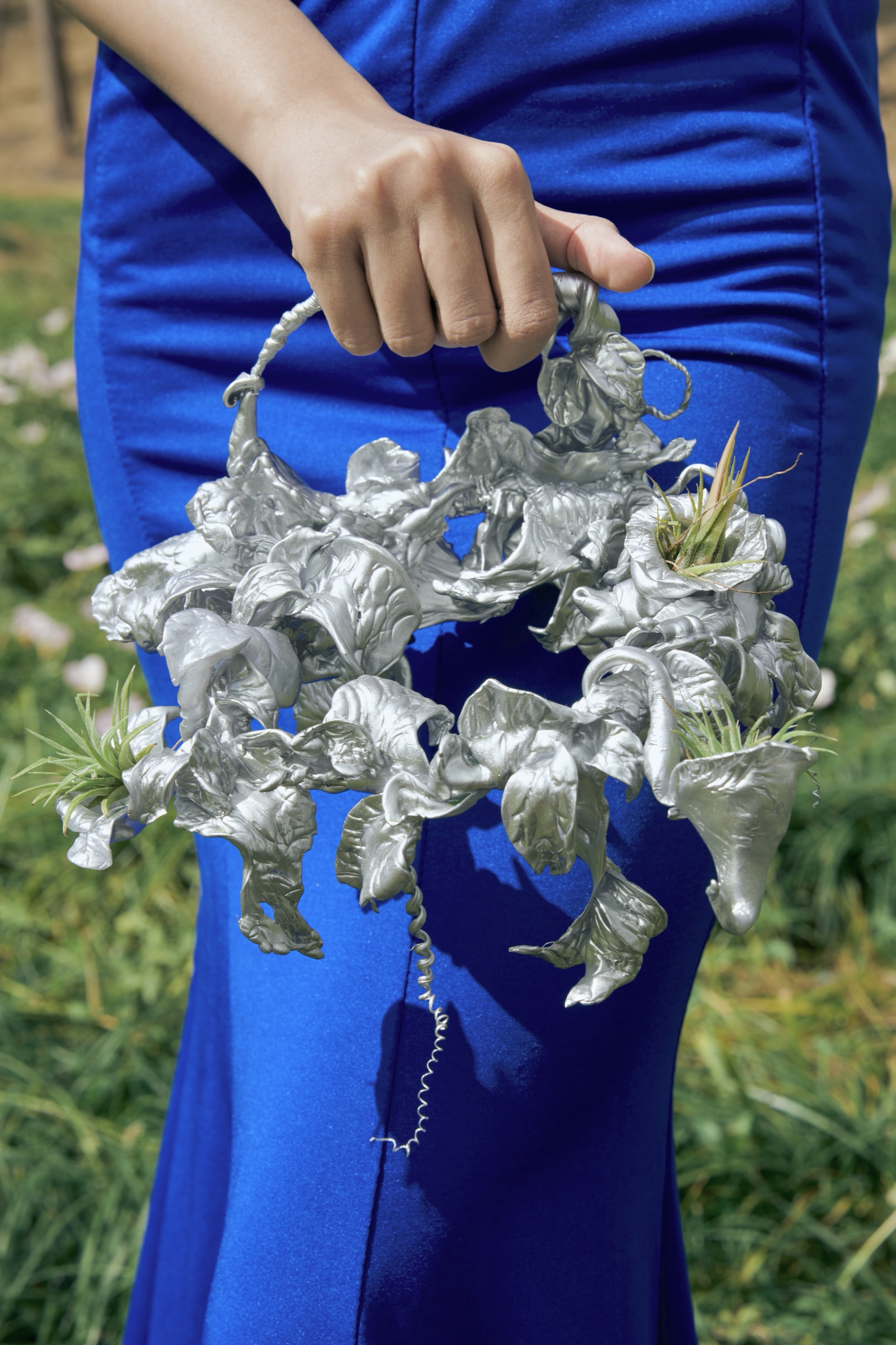 The Rhythm crown bag held against blue dress