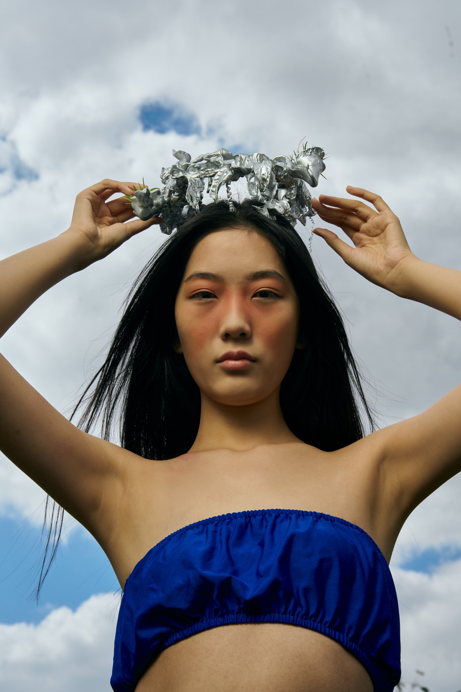 The Rhythm crown worn against sky