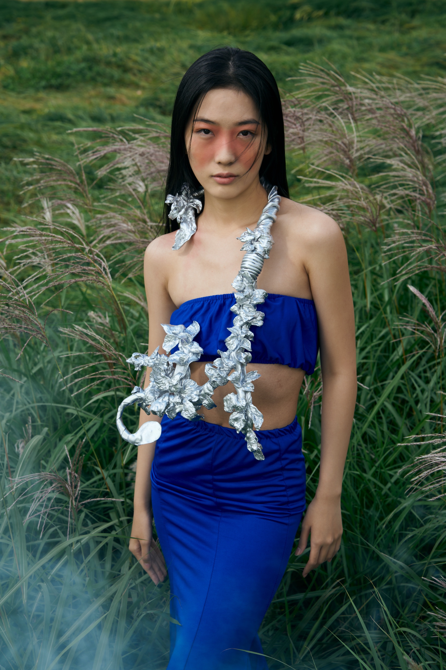 The Rhythm necklace in grass field