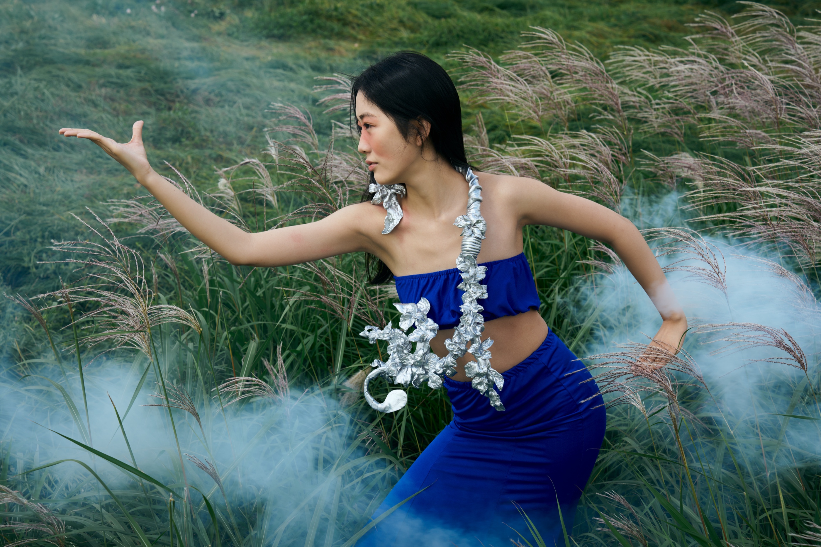 The Rhythm necklace with smoke and gesture